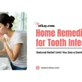 Title graphic reading "Home Remedies for Tooth Infection: Natural Relief Until You See a Dentist" by totkay.com. The image shows a woman standing in front of a bathroom mirror, holding a glass of water, and looking into her mouth with concern.